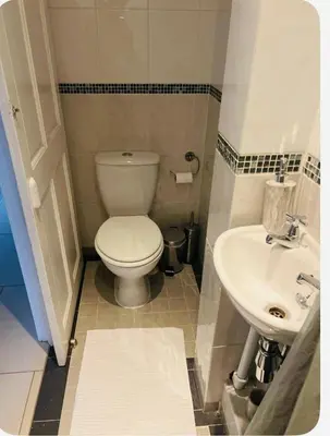 a small bathroom with a toilet and a sink at Bank West in Edinburgh