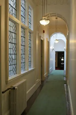 a hallway of a building with windows and a hallway sidx sidx sidx at The Billiard Room Flat