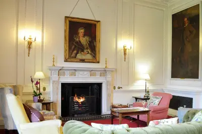 a living room with couches and a fireplace at The Billiard Room Flat
