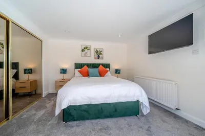 a bedroom with a large bed and a flat screen tv at 3 Bed in Leswalt oc-g32241 in Leswalt