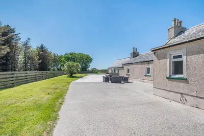 a driveway leading to a house with a fence at 3 Bed in Leswalt oc-g32241 in Leswalt