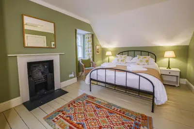 a bedroom with a bed and a fireplace at Craigendarroch No 1 in Acharn