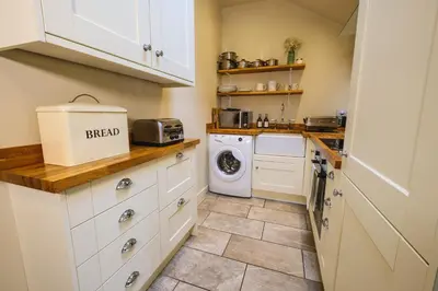 a kitchen with a washer and dryer at Craigendarroch No 1 in Acharn