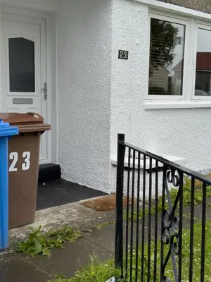 a front door of a house with a gate at Clydebank 2 Bedroom Home in Drumchapel