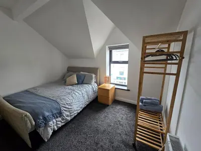 a bedroom with a bunk bed and a ladder at Central Portrush Townhouse available for Open Golf in Moffat