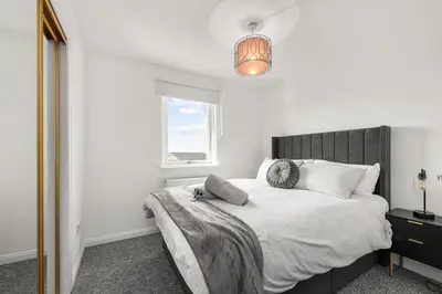 a bedroom with a bed and a window at Ochil View 30 mins to Edinburgh and Glasgow in Falkirk