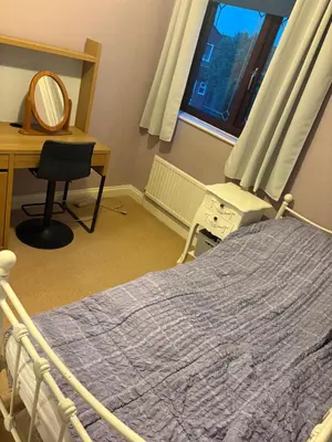 a bedroom with a bed and a desk and a desk at Single Room in Moffat