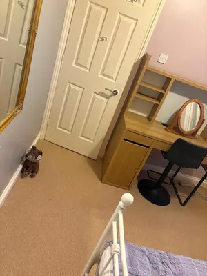 a bedroom with a door and a chair and a mirror at Single Room in Moffat