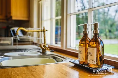 two bottles of vinegar sitting on a counter in a kitchen at Achranich House in Lochaline