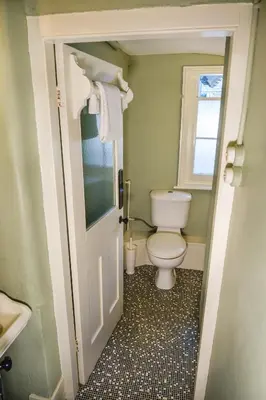 a small bathroom with a toilet and a window at Achranich House in Lochaline