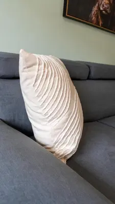 a pillow sitting on top of a couch at Tummel Place in Grangemouth