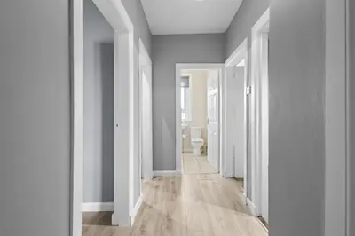 a hallway with white walls and a toilet in it at Welcoming Home in Hurlford, Kilmarnock - Bonnie Lodgings in Hurlford