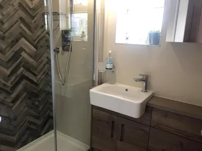 a bathroom with a sink and a shower at Granite House in Carsphairn