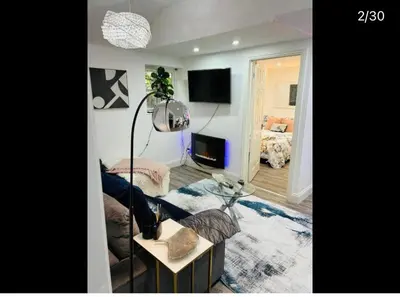 a living room with a couch and a table with a lamp at Hertford detached home garden pet friendly parking in Moffat