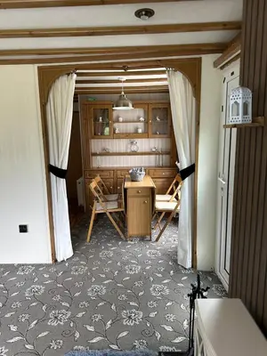 a room with a table and chairs in a room at 77 Glenfinart Caravan Park in Dunoon