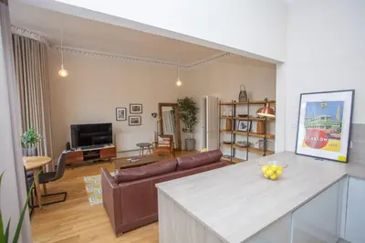 a living room with a couch and a table at Spacious Period Property in Glasgow in Glasgow