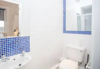 a bathroom with a toilet and a tub and a sink at Spacious Period Property in Glasgow in Glasgow