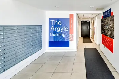 an entrance to a building with a large sign on the wall at Argyle Street Apartments in Glasgow