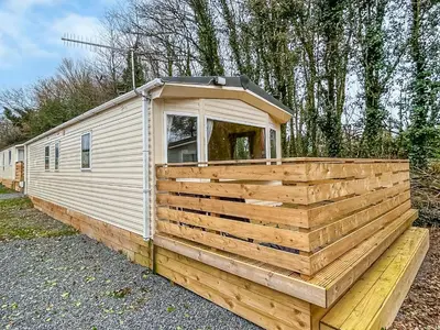 a wooden trailer with a cabin on top of it at Platinum in Newton Stewart