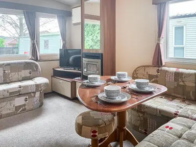 a living room with a table and two couches at Platinum in Newton Stewart
