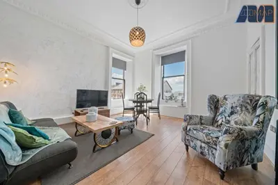 a living room with two chairs and a tv at Modern 2 Bed Sleep 4 In Gourock in Gourock