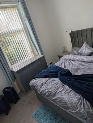a bedroom with a bed and a window at Largs seaside retreat in Largs