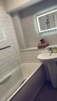 a bathroom with a sink and a bath tub and a sink at Casa da Paz in Glasgow