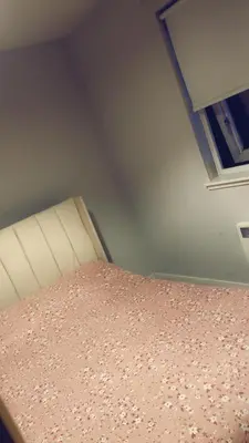 a bedroom with a bed and a window at Casa da Paz in Glasgow