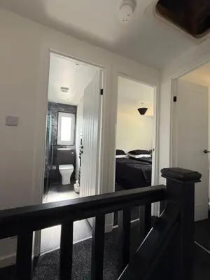 a room with a hallway with a bed and a toilet at Home Comfort Prestwick in Prestwick