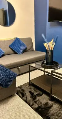 a living room with a couch and a table at HULL 2BED Sleeps 4 BETTO Cosy Home! in Moffat