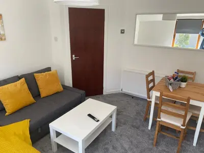 a living room with a couch and a table at Glen Cannich - Top Location, 2BR Accessible apt in Inverkeithing