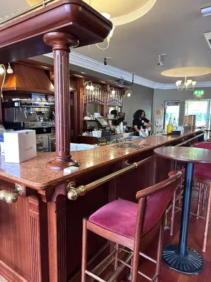 a bar with a purple stool in a restaurant at The Villa Hamilton in Hamilton