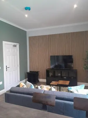 a living room with a couch and a flat screen tv at Outlander 4 Apartment Doune in Stirling