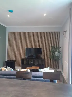 a living room with a couch and a flat screen tv at Outlander 4 Apartment Doune in Stirling
