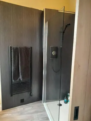 a shower with a glass door in a bathroom at Outlander 4 Apartment Doune in Stirling