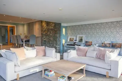 a living room with two couches and a table at 5 Bed Family Home Lochwinnoch in Lochwinnoch
