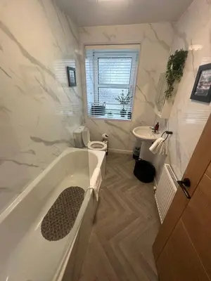 a bathroom with a tub and a toilet and a sink at BOFA Snug Apartment in Bridge of Allan