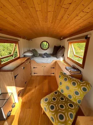 a small room with a bed and a desk at The Shepherd's Hut in Craighouse