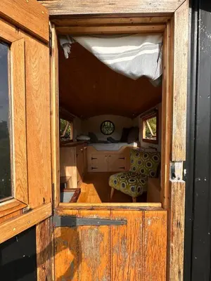 an open door of a room with a table and chairs at The Shepherd's Hut in Craighouse