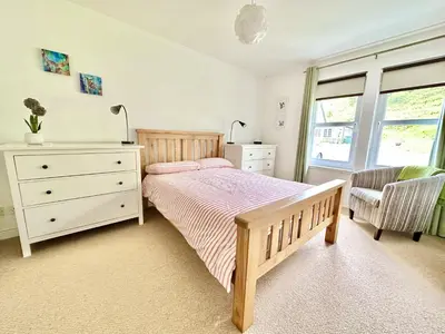 a bedroom with a bed and a dresser and a window at Barrmor View in Kilmartin