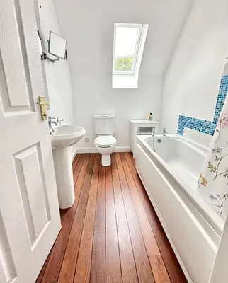 a bathroom with a toilet and a tub and a sink at Barrmor View in Kilmartin