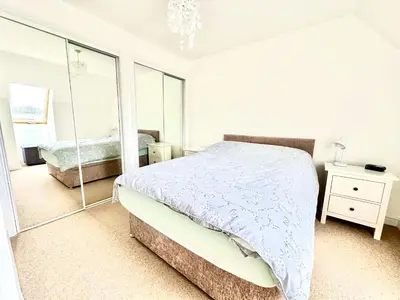 a bedroom with a bed and a mirror at Barrmor View in Kilmartin
