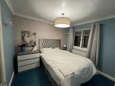 a bedroom with a white bed and a window at Glasgow 3 bed Guest House in Glasgow