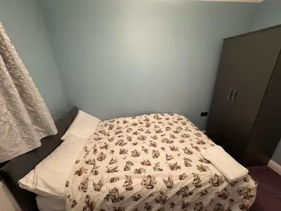 a bedroom with a bed with a blanket on it at Glasgow 3 bed Guest House in Glasgow