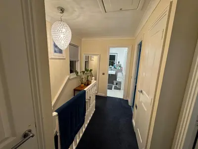 a hallway of a home with a blue floor at Glasgow 3 bed Guest House in Glasgow