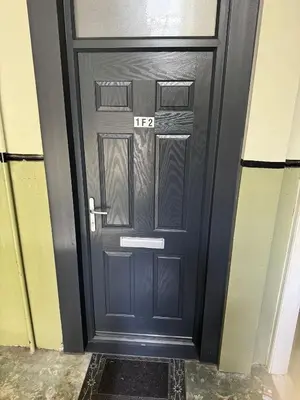 a black door with the number on it at Fountain park get away one bedroom in a 2 bedroom apartment in Edinburgh