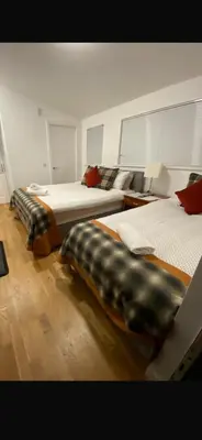 a bedroom with two beds with pillows on them at Rowardennan Rooms in the lodge Lodge no 2 in Rowardennan