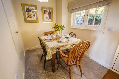 a dining room with a table and chairs at Craigendarroch No 2 in Acharn