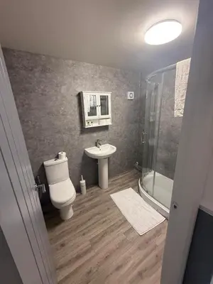 a bathroom with a toilet and a sink and a shower at City Centre 2 Bed Apartment in Glasgow
