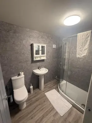 a bathroom with a toilet and a sink and a shower at City Centre 2 Bed Apartment in Glasgow
